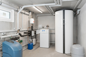  Aufgeräumte Heizungskeller: die Luft/Wasser-Wärmepumpe als zentrale Einheit in der Mitte, rechts der Multifunktionsspeicher, sowie links eine Wasseraufbereitung. 