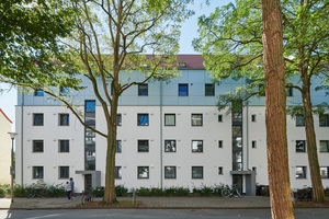  Die farblich und materiell abgesetzte Fassade der aufgestockten Gebäude lockert das Ensemble optisch auf zurückhaltende Art auf 