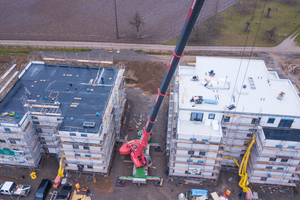  Ein Schwerlastkran hebt die Module auf der Baustelle an Ort und Stelle. In nur 6 Monaten Bauzeit entstanden so 44 Wohnungen 