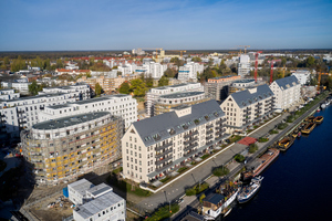  Am Ufer der Havel entsteht in Berlin-Spandau im Auftrag der BUWOG das „Speicherballett“. Es besteht aus 14 Gebäuden mit unterschiedlicher Kubatur 