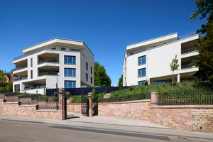  Historische Elemente wie die die schmiedeeiserne Zaun- und Toranlage sind konzeptuell in die Gestaltung eingebunden 