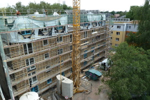  Oben wurde gerade das neue Staffelgeschoss in Holzleichtbauweise aufgesetzt. In den Bestandsgeschossen darunter ist die Unterkonstruktion der neuen Fassadendämmung montiert, die mit Zelluloseflocken ausgeführt wurde 